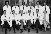 Formal photo showing a group of physicians in white coats.
